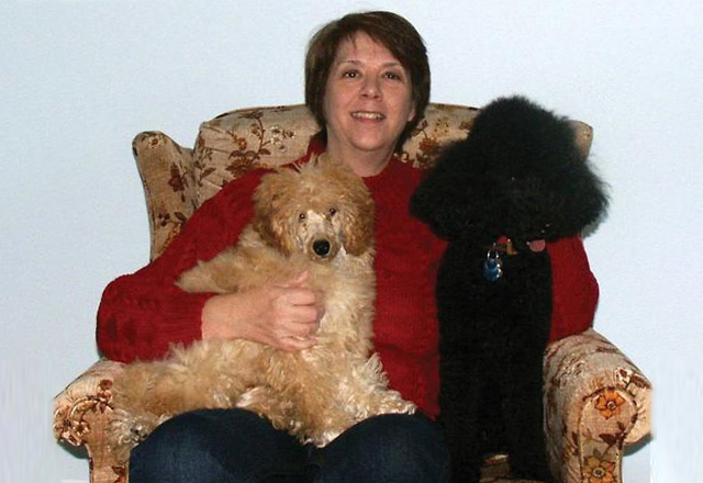 Leslie Pfenninger, pictured with poodles Justice and James