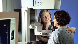 A woman gets a mammogram.